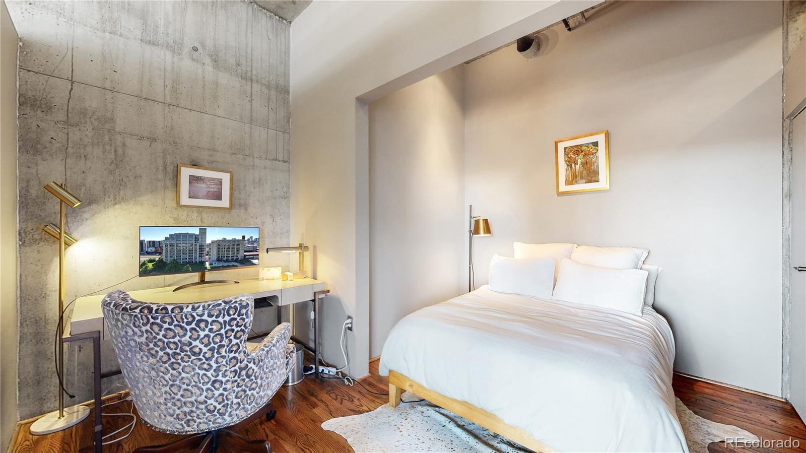 2000 Little Raven Street, Unit 702 Denver, CO 80202 - Photo 19 of 48 a bedroom with a bed and window