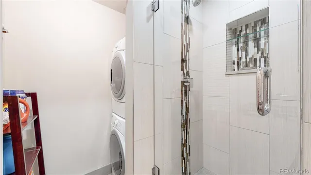 a bathroom with a granite countertop shower and a mirror