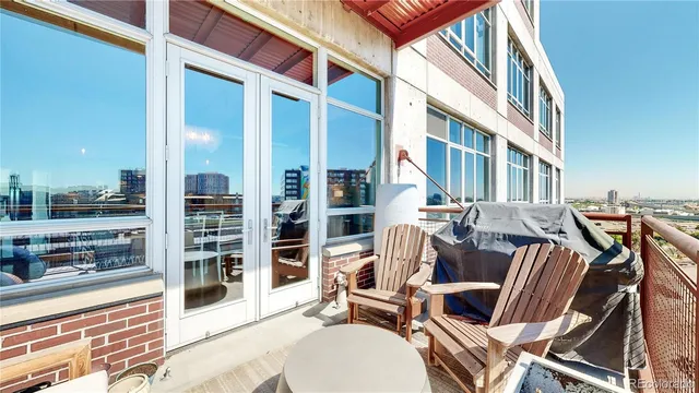 a view of a patio with a table and chairs