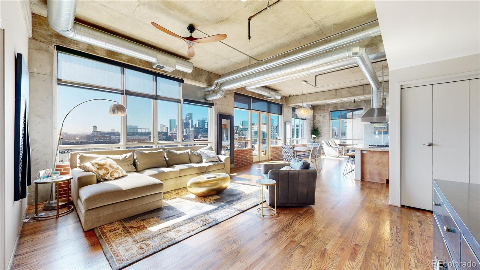 2000 Little Raven Street, Unit 702 Denver, CO 80202 - Photo 5 of 48 a living room with furniture large window and wooden floor
