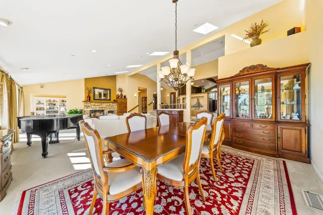 a dining room with furniture a chandelier and wooden floor