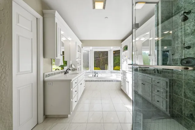 a large white kitchen with a large window