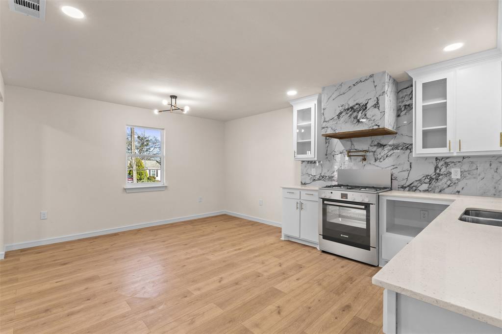 4325 Highland Street Lancaster, TX 75134 - Photo 12 of 35 a kitchen with stainless steel appliances granite countertop a stove and a sink