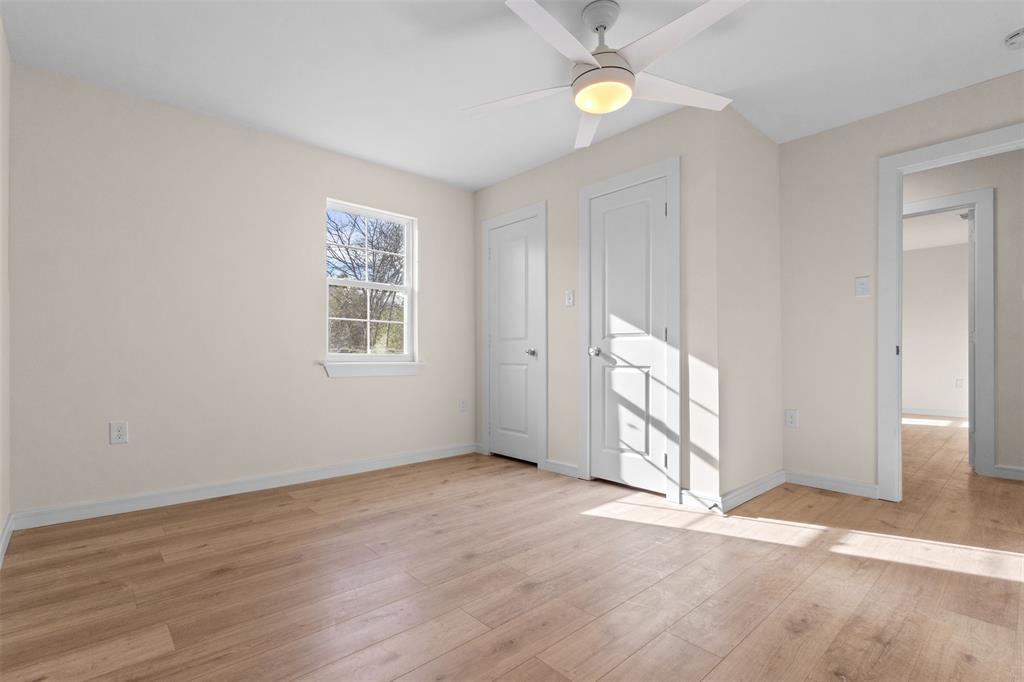 4325 Highland Street Lancaster, TX 75134 - Photo 15 of 35 an empty room with wooden floor and windows