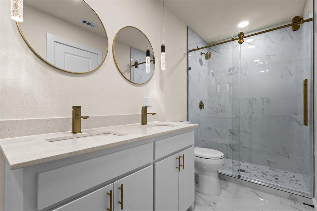 4325 Highland Street Lancaster, TX 75134 - Photo 17 of 35 a bathroom with a sink a toilet and a mirror