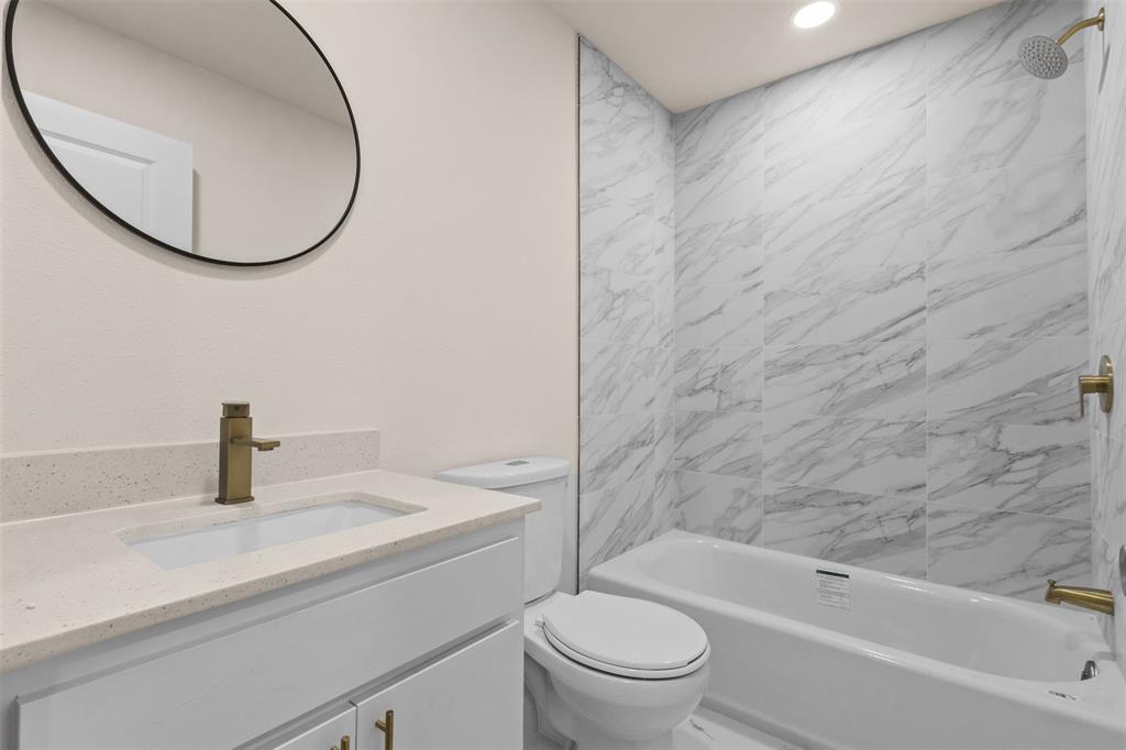 4325 Highland Street Lancaster, TX 75134 - Photo 21 of 35 a bathroom with a sink a toilet and a bathtub