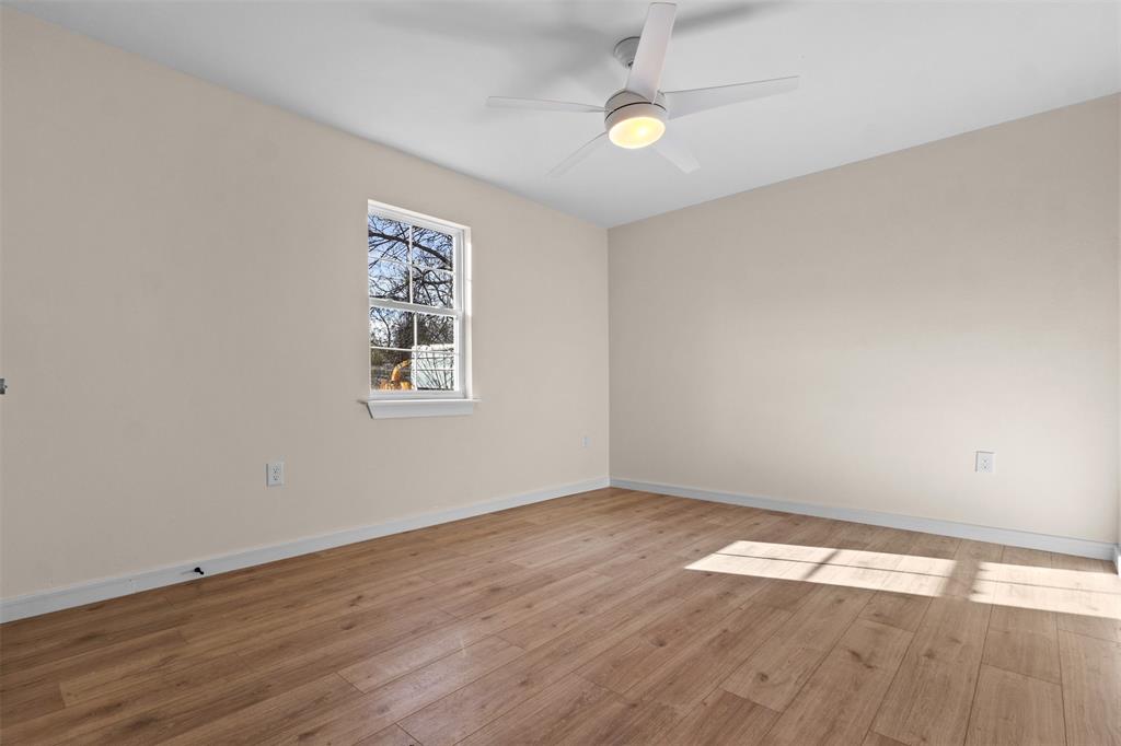 4325 Highland Street Lancaster, TX 75134 - Photo 24 of 35 an empty room with wooden floor and windows