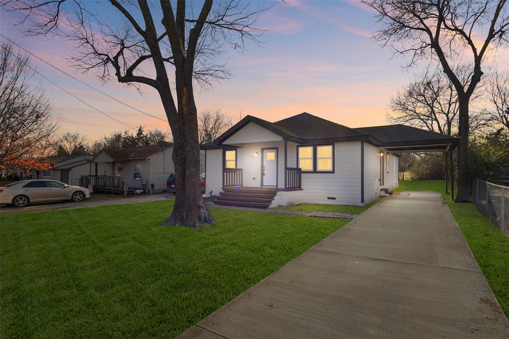 4325 Highland Street Lancaster, TX 75134 - Photo 4 of 35 a front view of a house with a garden and trees
