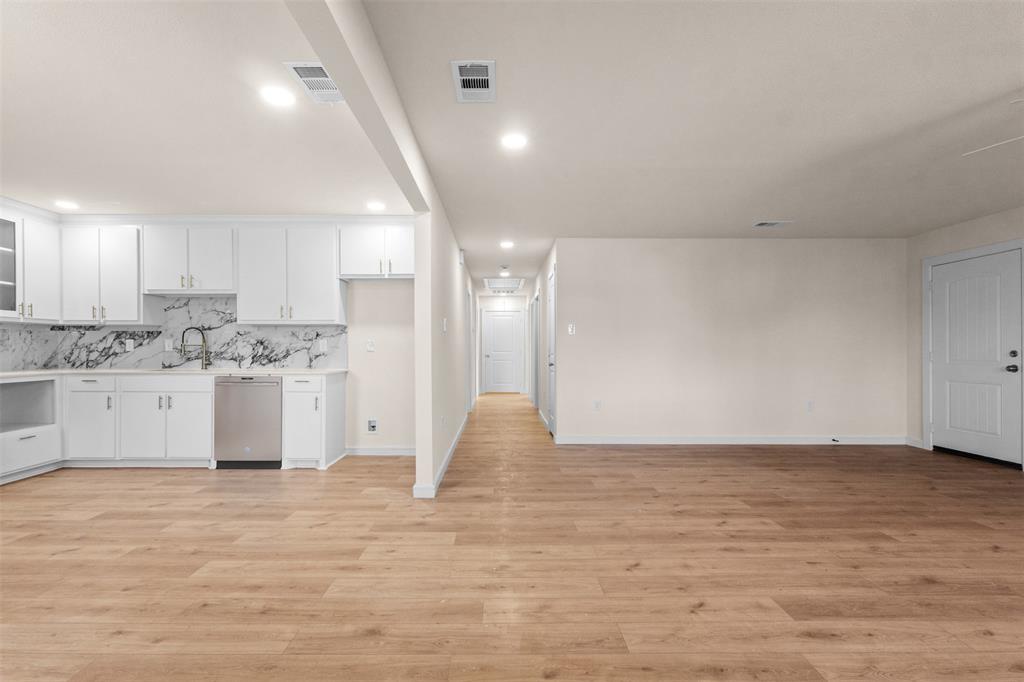 4325 Highland Street Lancaster, TX 75134 - Photo 5 of 35 a view of a kitchen with white cabinets and wooden floor