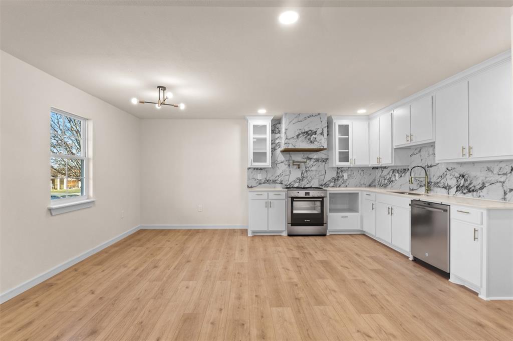4325 Highland Street Lancaster, TX 75134 - Photo 9 of 35 a kitchen with granite countertop a sink cabinets and stainless steel appliances