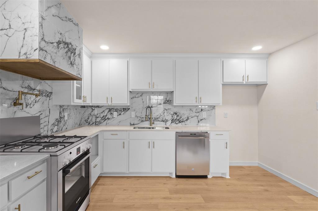 4325 Highland Street Lancaster, TX 75134 - Photo 10 of 35 a kitchen with stainless steel appliances granite countertop a stove and a sink
