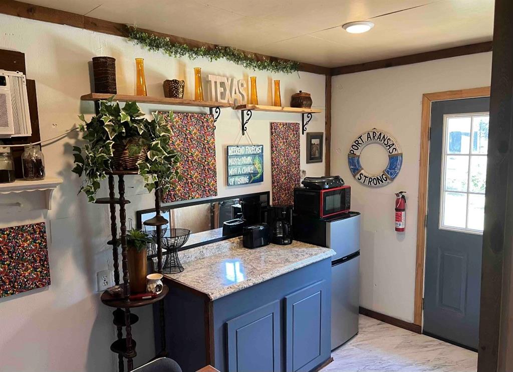 a kitchen with sink refrigerator and microwave