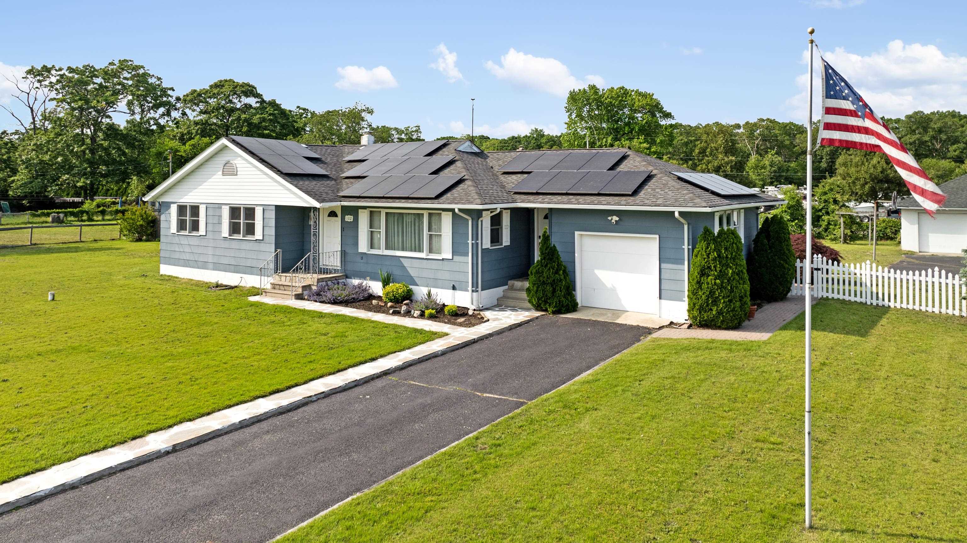 102 Teal Road Rio Grande, NJ 08242 - Photo 1 of 49 a front view of a house with a yard and potted plants