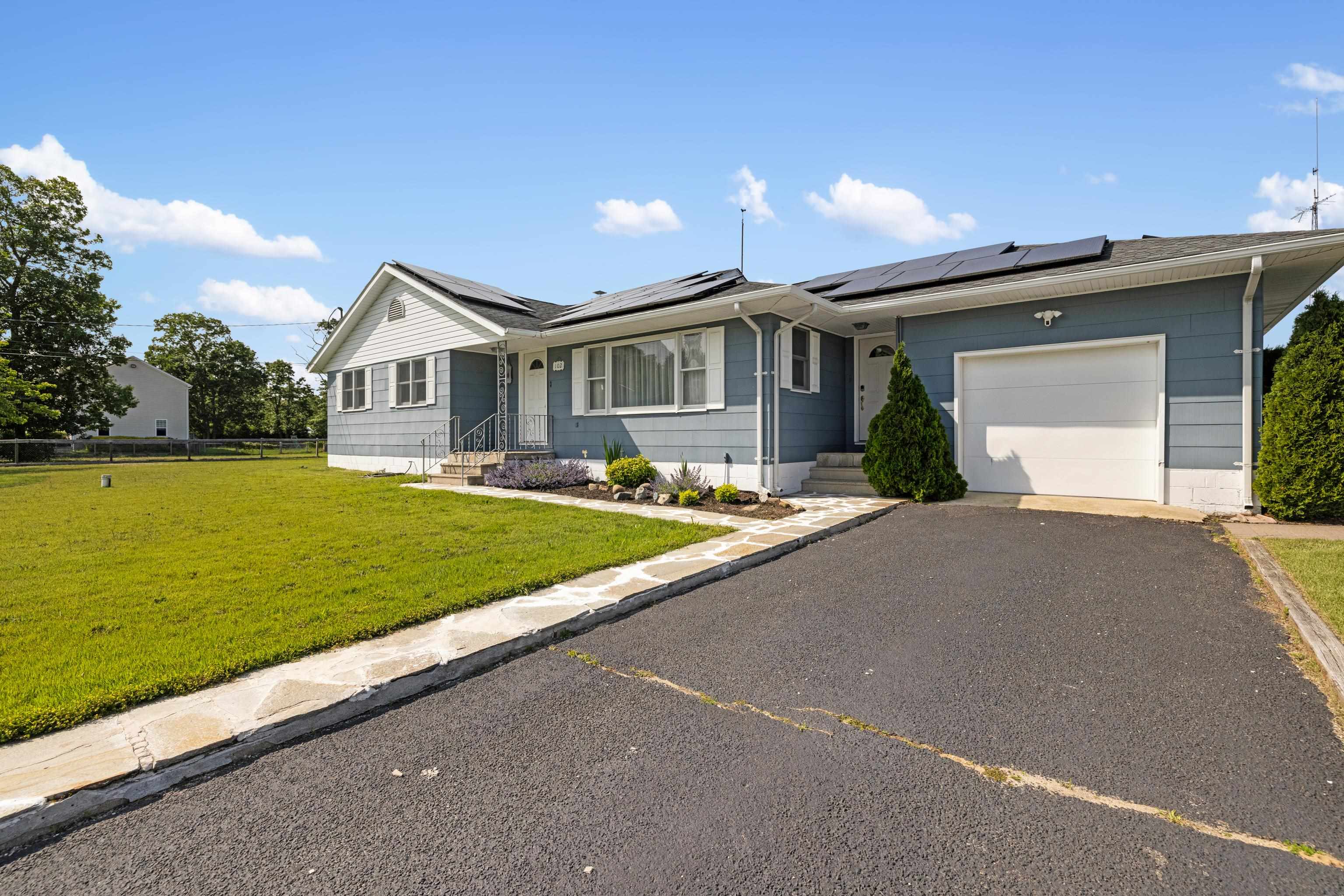 102 Teal Road Rio Grande, NJ 08242 - Photo 12 of 49 a view of a house with a yard and a garage