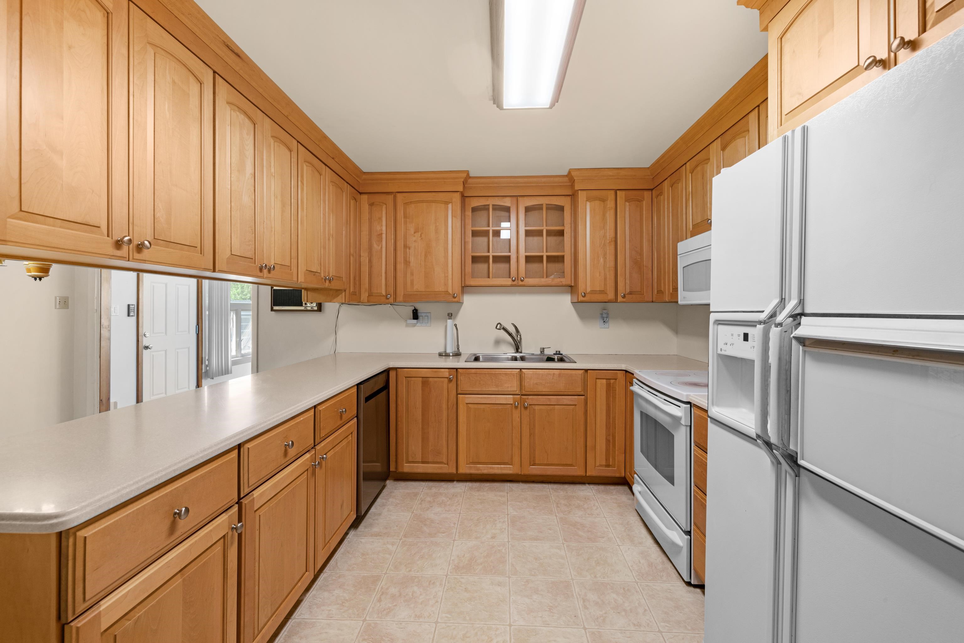 102 Teal Road Rio Grande, NJ 08242 - Photo 19 of 49 a kitchen with granite countertop a sink stainless steel appliances and cabinets