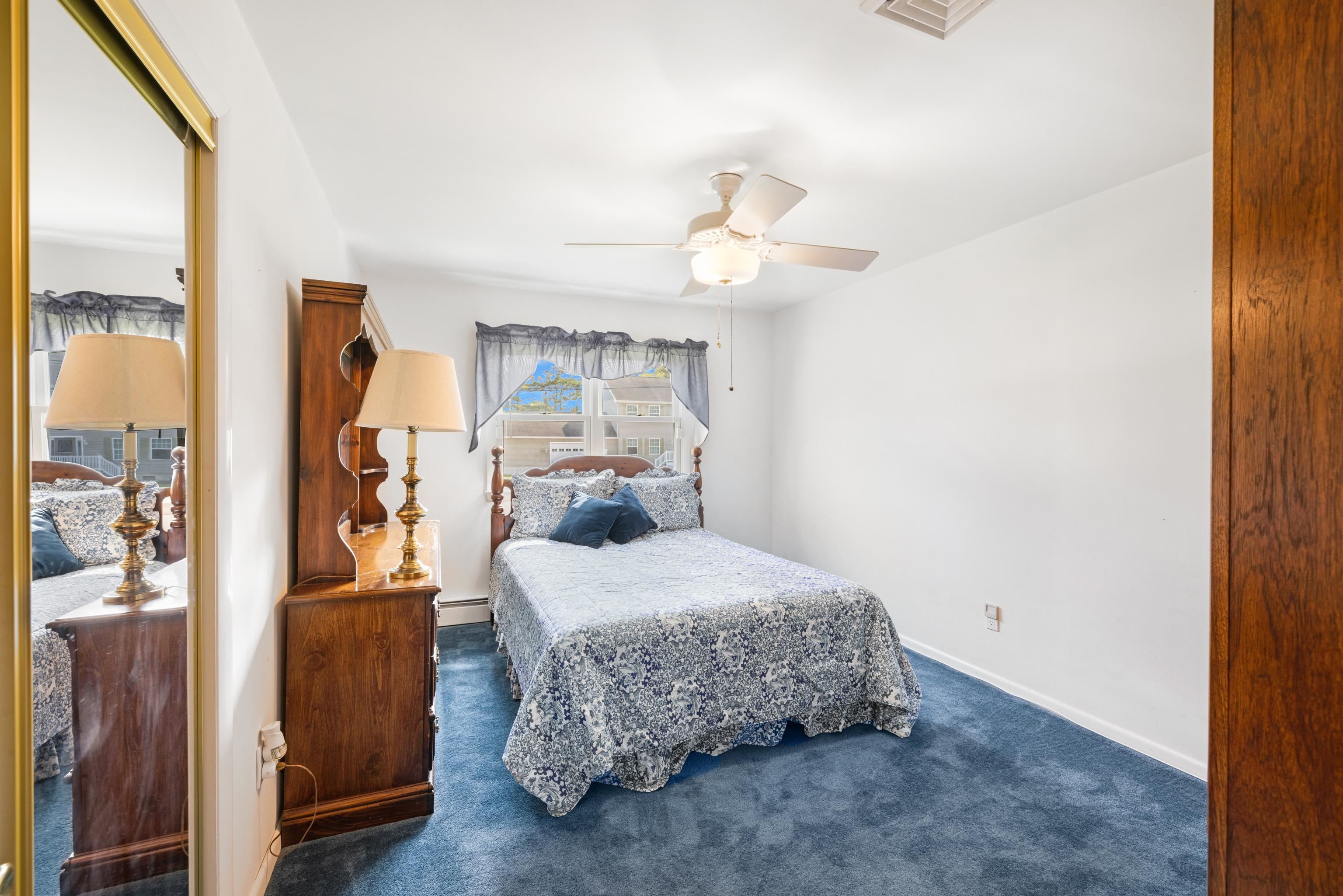 102 Teal Road Rio Grande, NJ 08242 - Photo 25 of 49 a bedroom with a bed and a chandelier