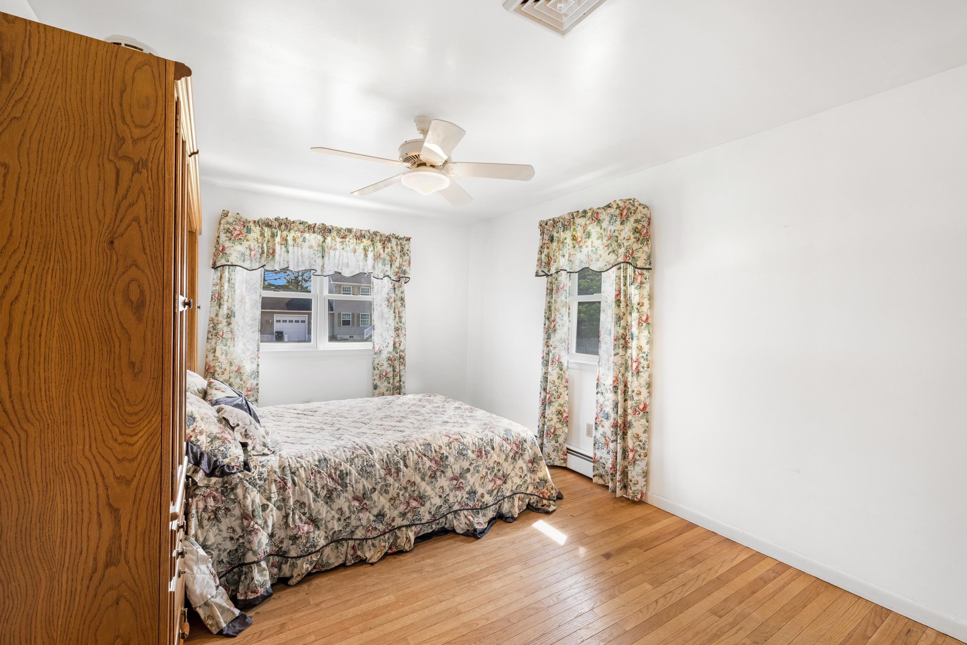 102 Teal Road Rio Grande, NJ 08242 - Photo 27 of 49 a bedroom with a large bed and wooden floor