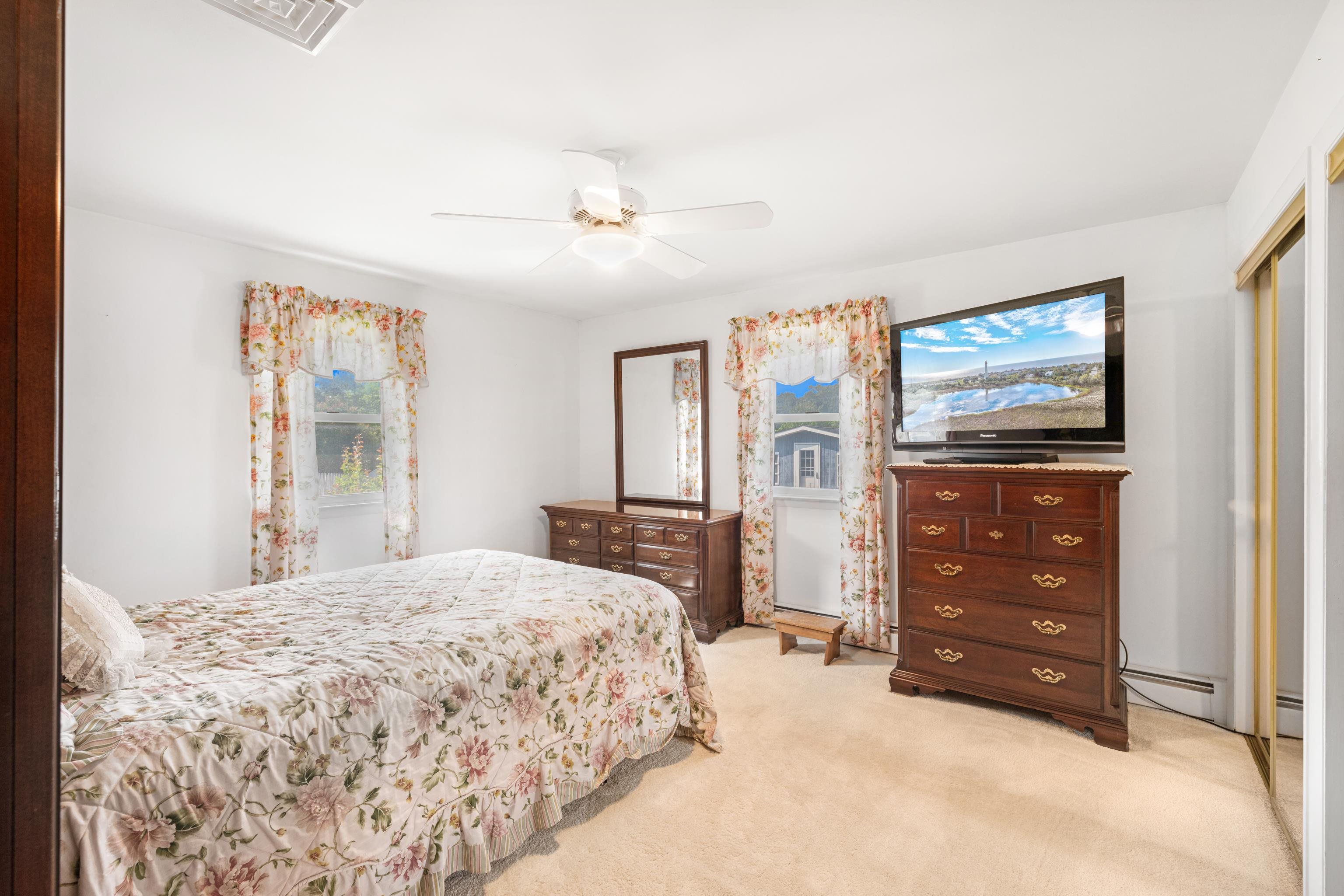 102 Teal Road Rio Grande, NJ 08242 - Photo 29 of 49 a bedroom with a bed a dresser and a window