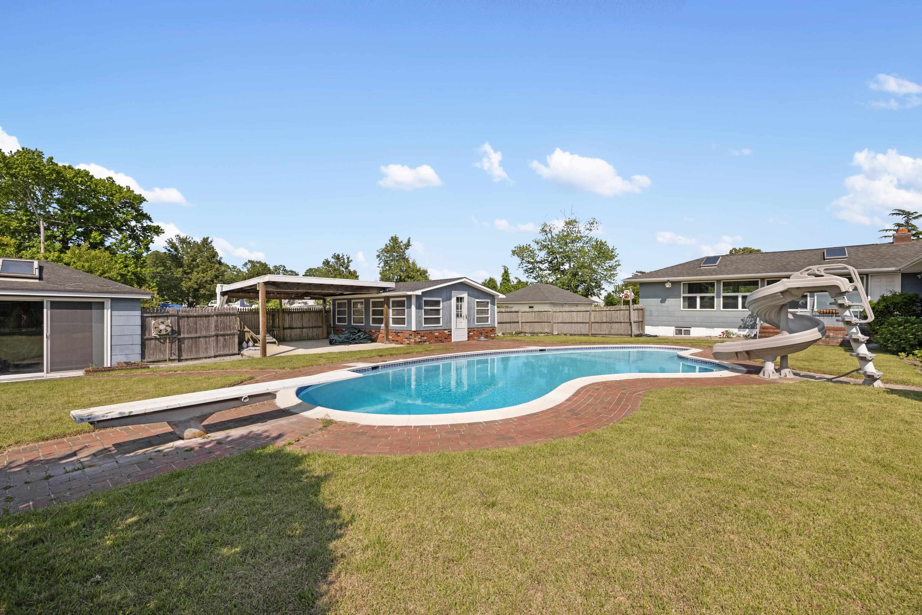 102 Teal Road Rio Grande, NJ 08242 - Photo 38 of 49 a view of a swimming pool with an outdoor space and seating area