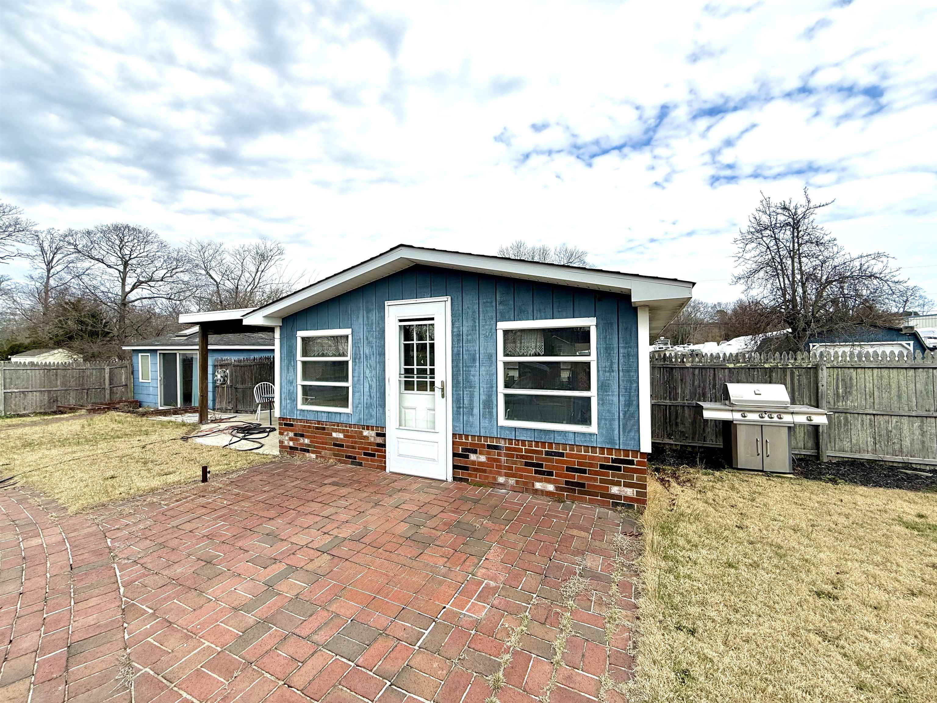 102 Teal Road Rio Grande, NJ 08242 - Photo 39 of 49 a backyard of a house with couches fire pit and barbeque oven