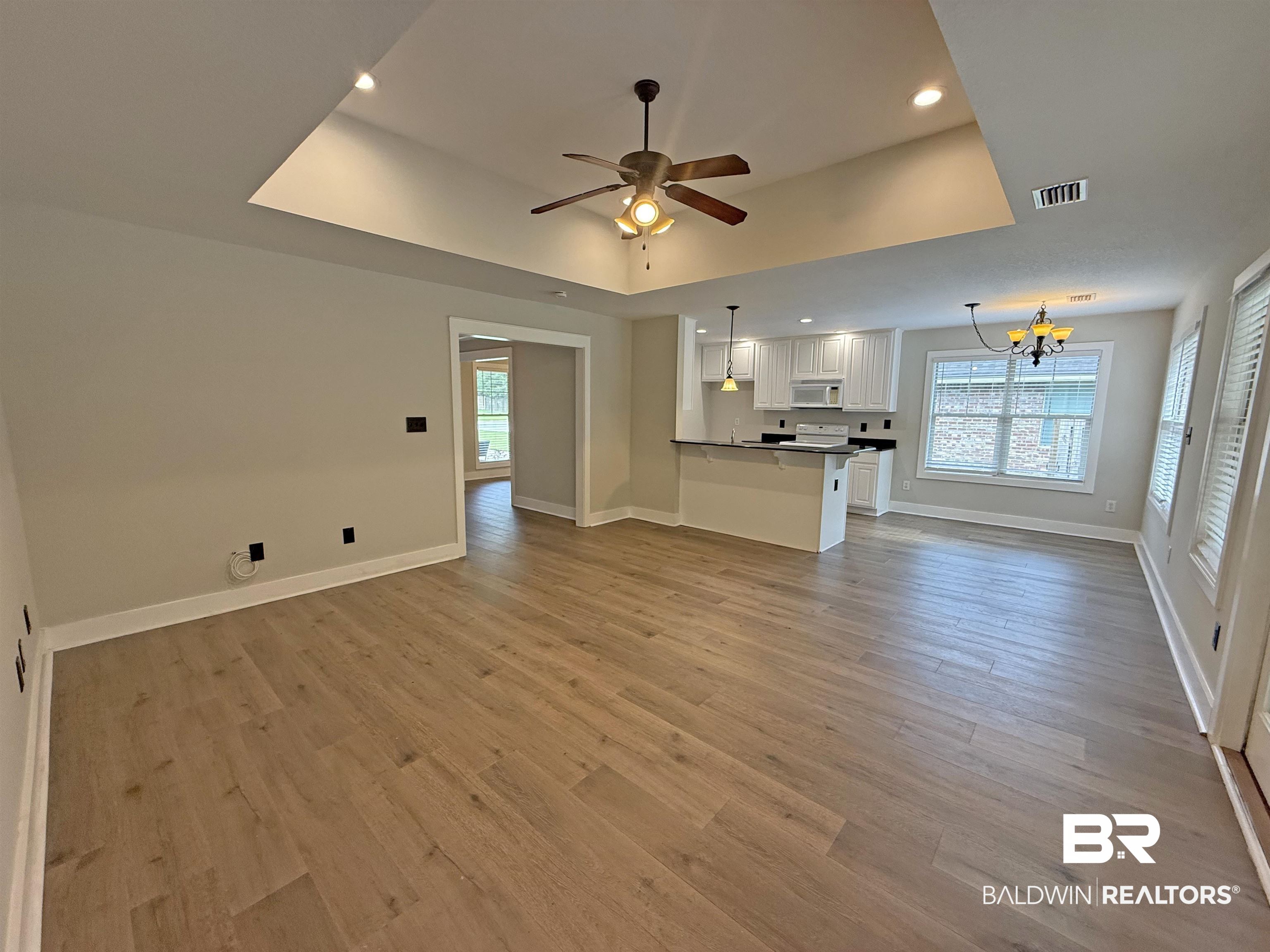 22023 Garland Loop Silverhill, AL 36576 - Photo 6 of 33 Unfurnished living room featuring a chandelier, ceiling fan, recessed lighting, and light wood-style flooring