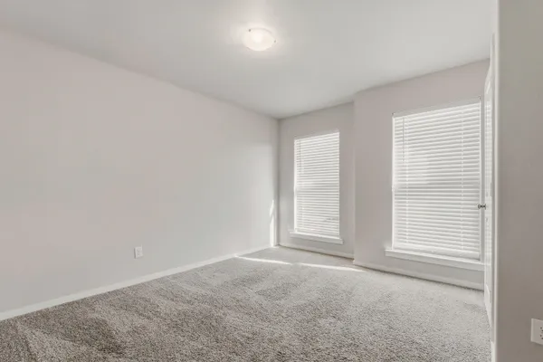 a view of a backyard with brick wall plants and a bench