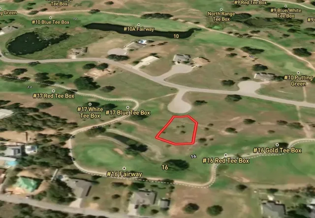 an aerial view of a residential houses with outdoor space