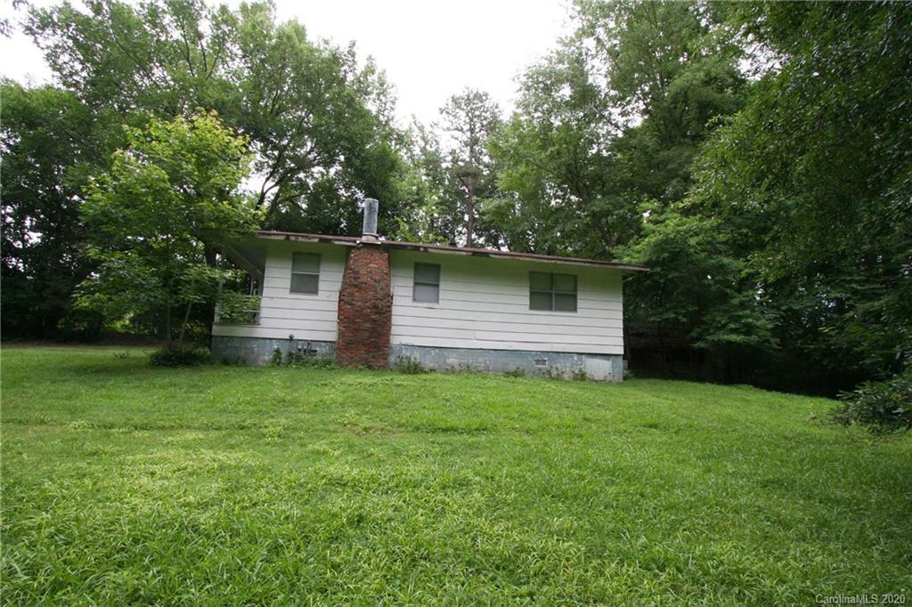 1400 Pleasant Plains Road Matthews, NC 28105 - Photo 11 of 31 a backyard of a house with plants and large tree
