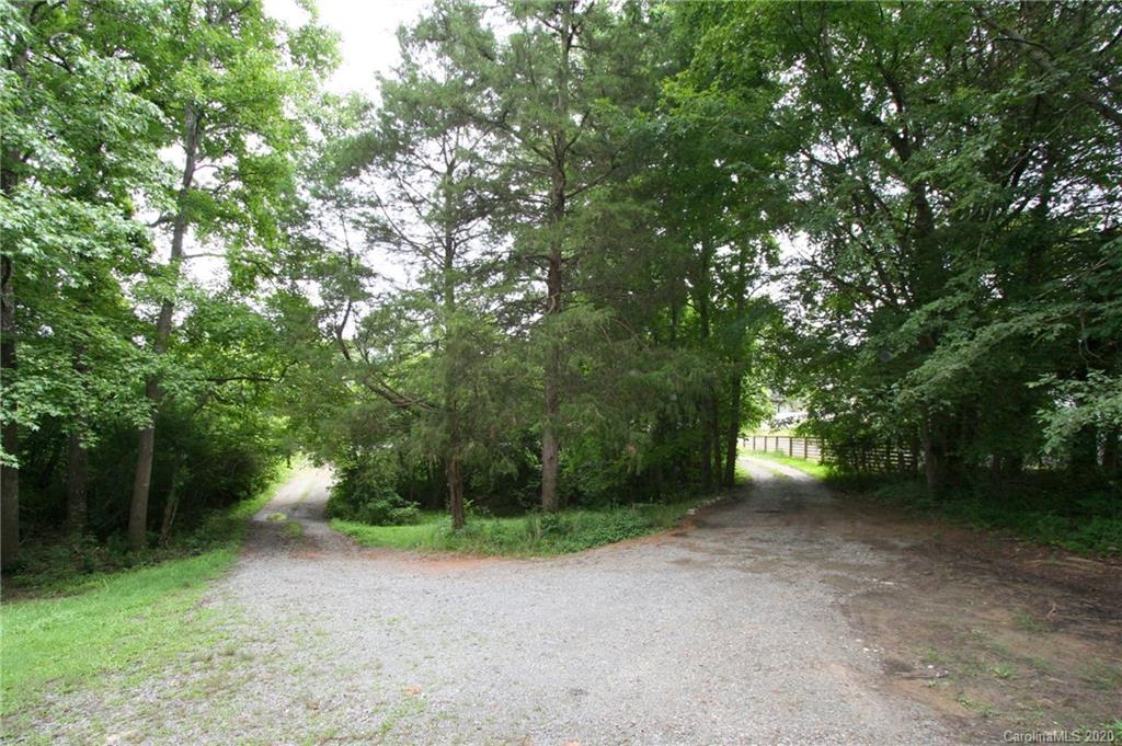 1400 Pleasant Plains Road Matthews, NC 28105 - Photo 3 of 31 a view of a yard with plants and large trees