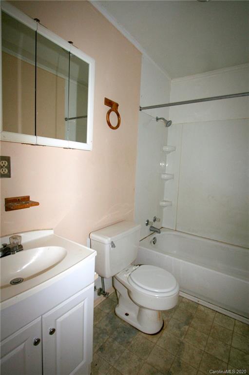 1400 Pleasant Plains Road Matthews, NC 28105 - Photo 23 of 31 a white toilet sitting next to a bathroom sink