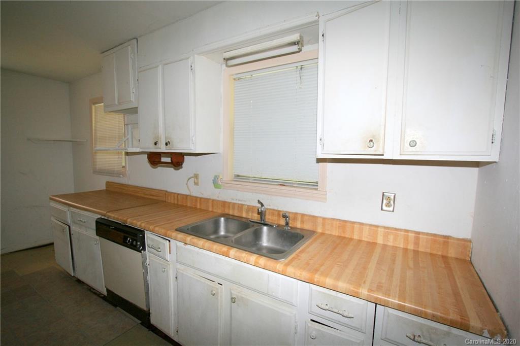 1400 Pleasant Plains Road Matthews, NC 28105 - Photo 28 of 31 a kitchen with granite countertop white cabinets and a sink