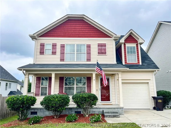 front view of brick house with potted plants