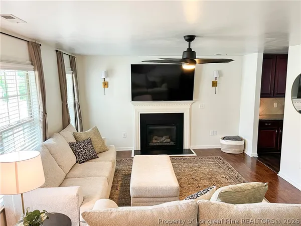 a living room with furniture and a fireplace