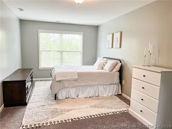a bedroom with a large bed and a window