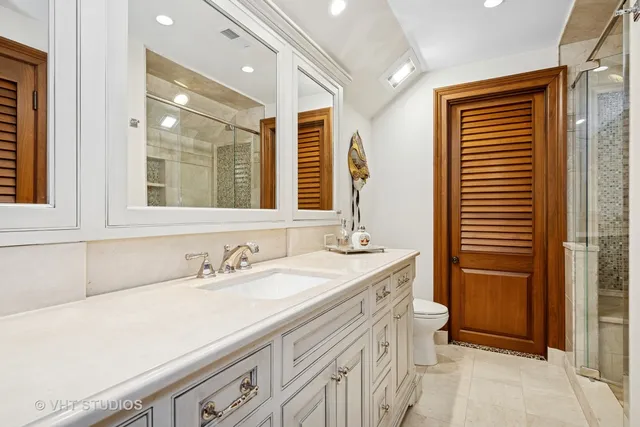 a bathroom with a granite countertop sink a shower and a mirror