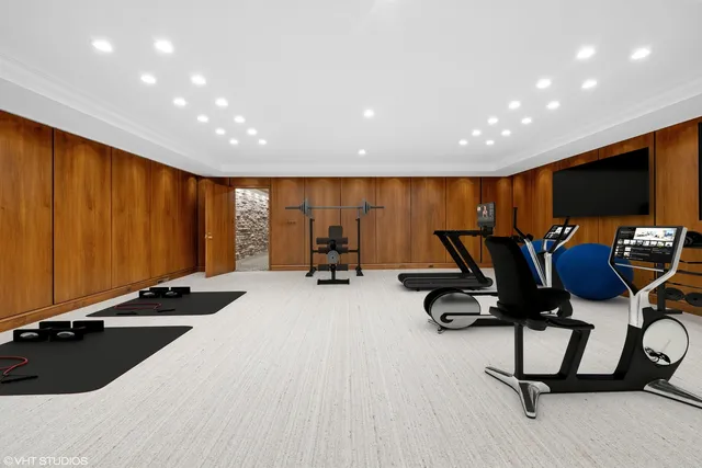 a picture of a room with a white wall and a refrigerator