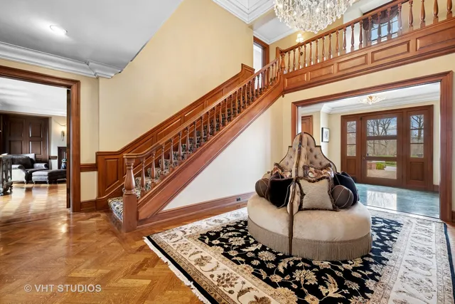 a living room with furniture a rug and a chandelier