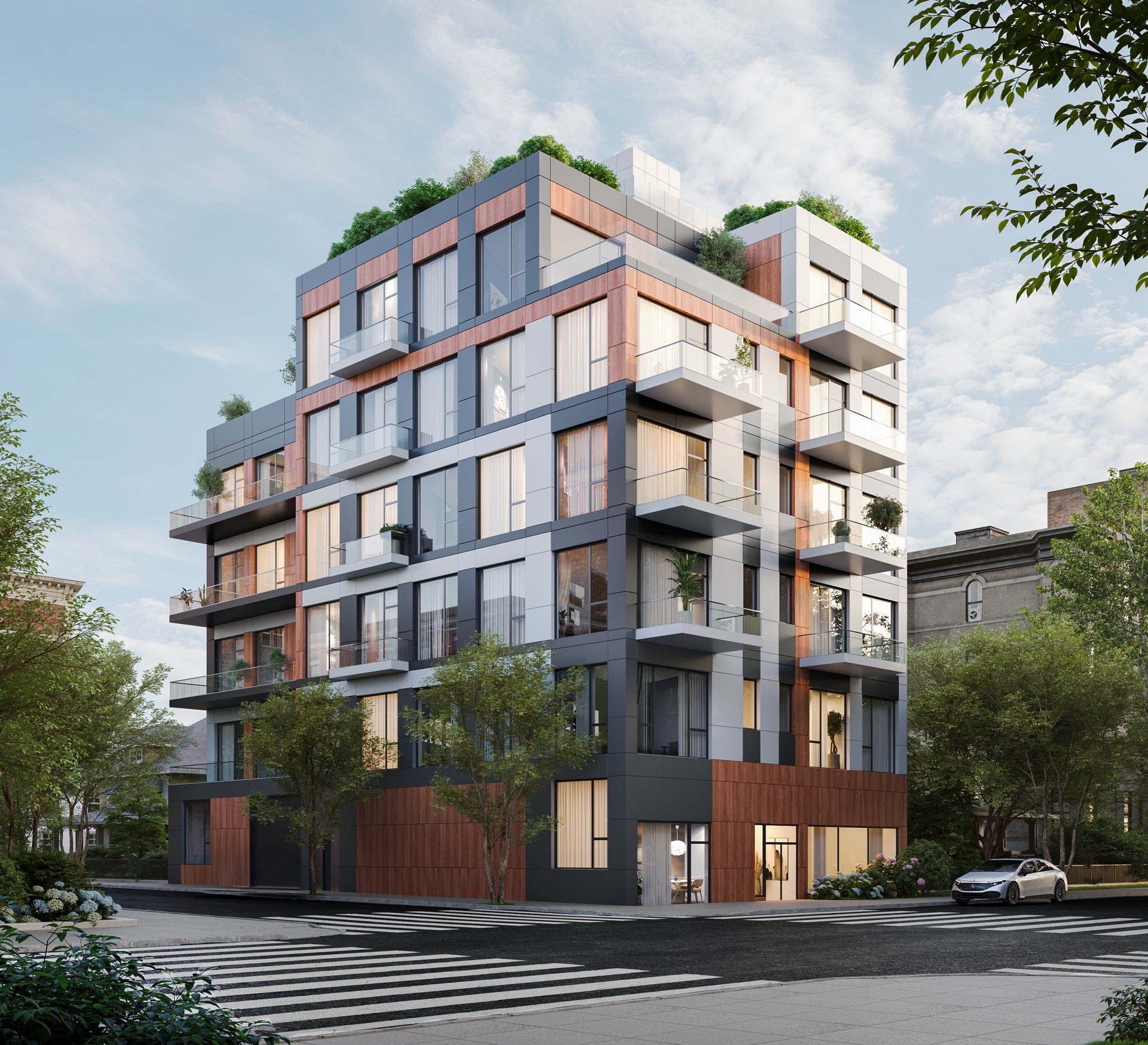 a front view of a multi story residential apartment building with yard and parking space