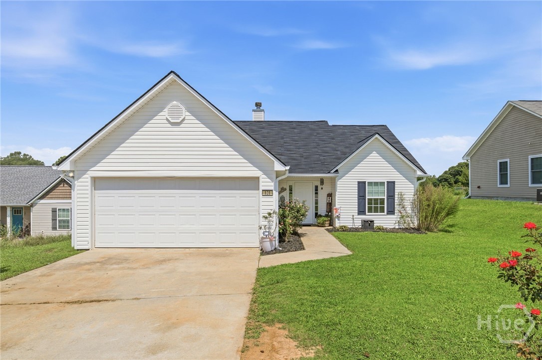 121 Crestview Drive Carnesville, GA 30521 - Photo 1 of 28 White exterior with a two-car garage, asphalt shingle roof, and a concrete driveway