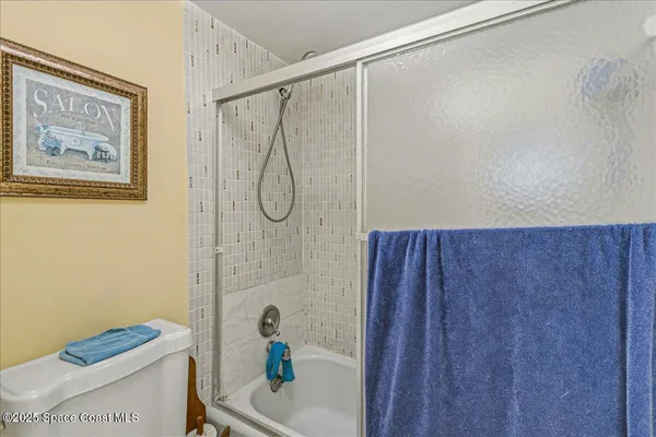 a bathroom with a shower and a toilet