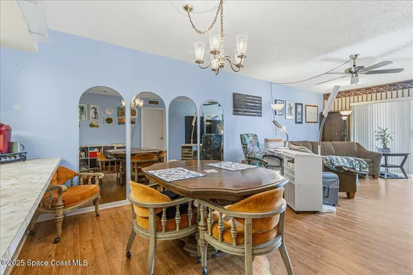 a view of a dining room with furniture and wooden floor
