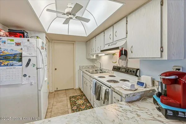 a kitchen with stainless steel appliances a stove a refrigerator and cabinets