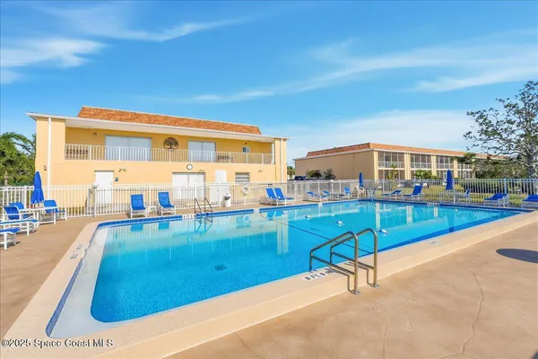 a view of a swimming pool with a lounge chair