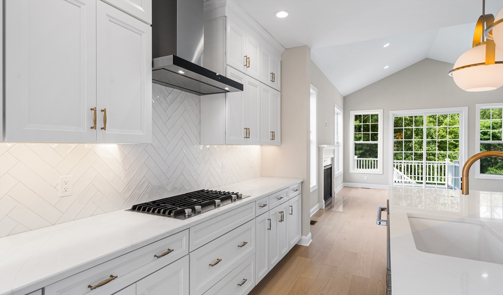 35 Ingalls Vlg Way, Unit 60 Boxford, MA 01921 - Photo 3 of 3 a kitchen with stainless steel appliances a stove a chimney a sink and cabinets
