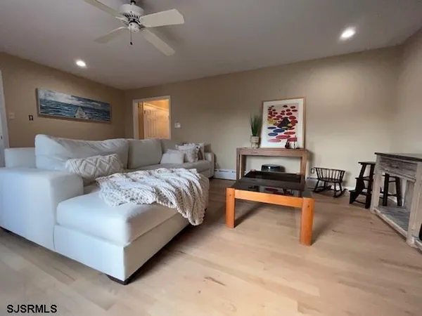 a spacious bedroom with a bed and a chandelier