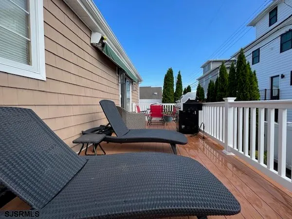 a roof deck with couch and chairs