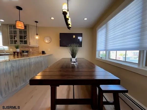 a view of a room with a table and chairs