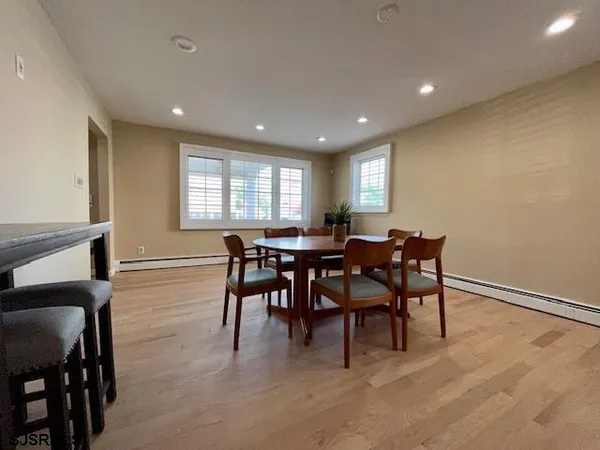 a view of a dining room with furniture and chandelier