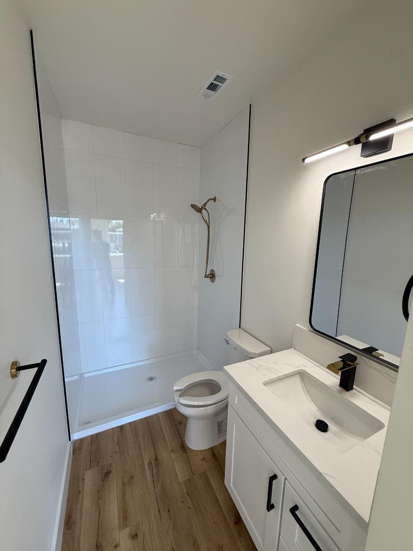 963 Olive Br Place, Unit 959 Sacramento, CA 95815 - Photo 6 of 12 a bathroom with a sink a toilet and shower