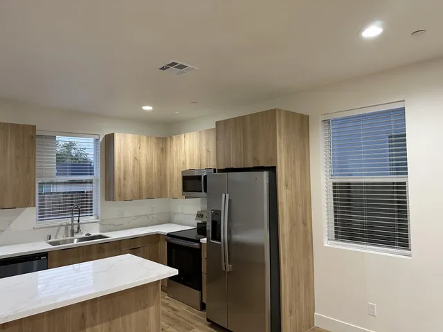 a kitchen with a refrigerator and a sink